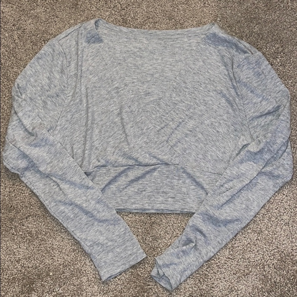 crossed long sleeved grey shirt